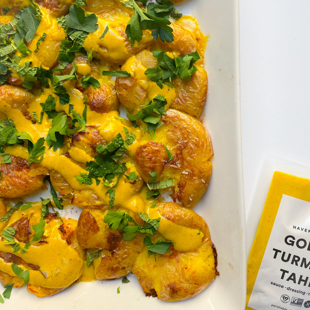 Crispy Smashed Potatoes with Golden Tahini and Herbs